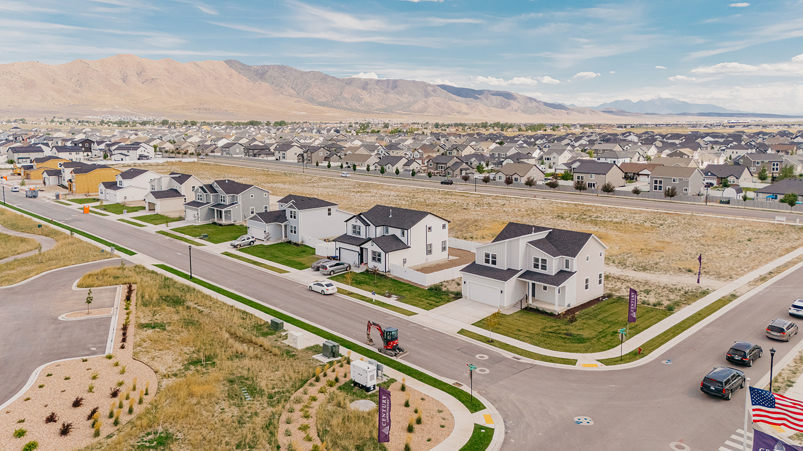 A neighborhood with a road and cars.