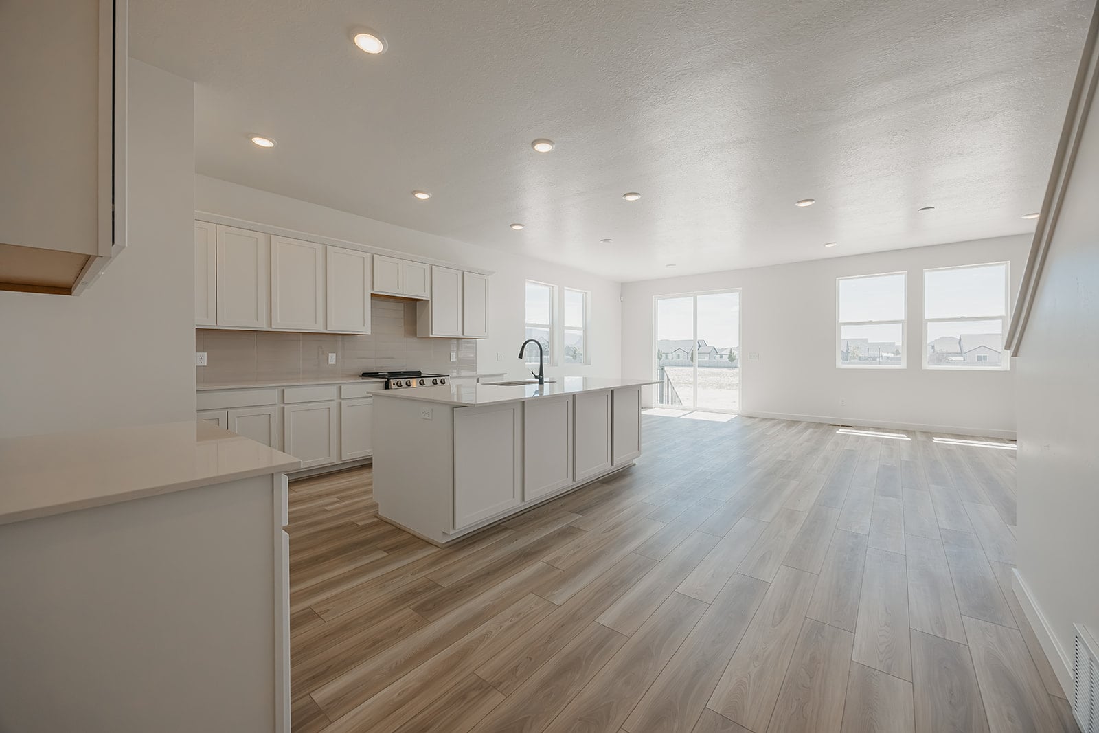A kitchen with white cabinets.