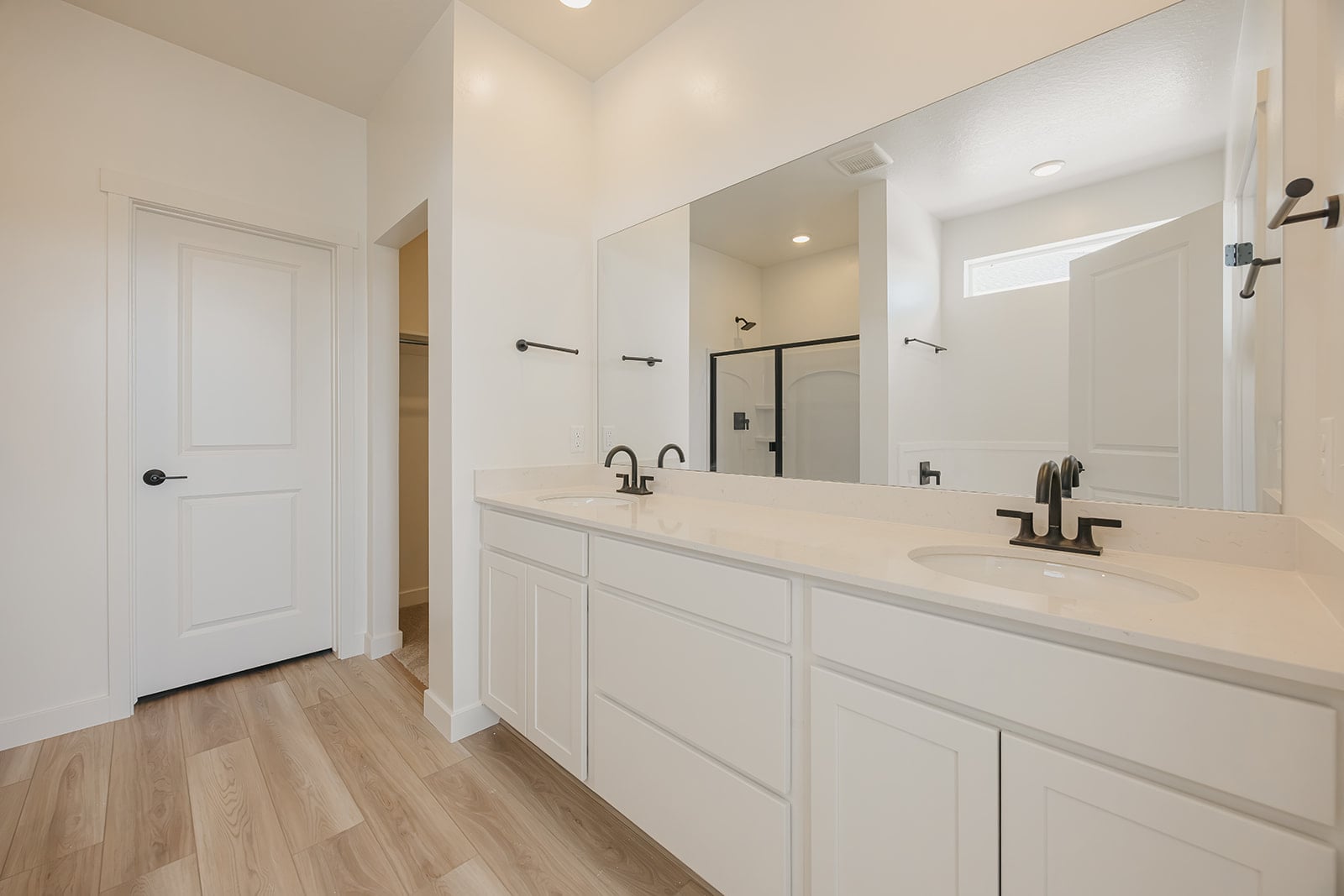 A bathroom with white cabinets.
