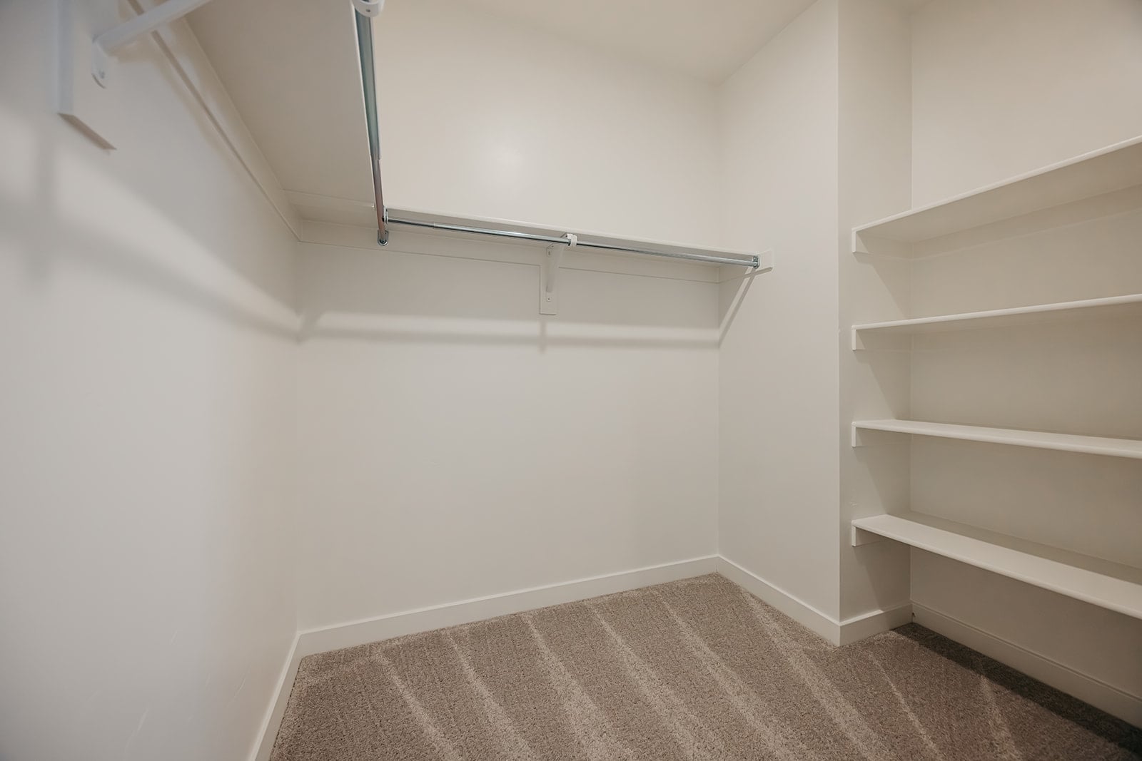 A white room with a rug.