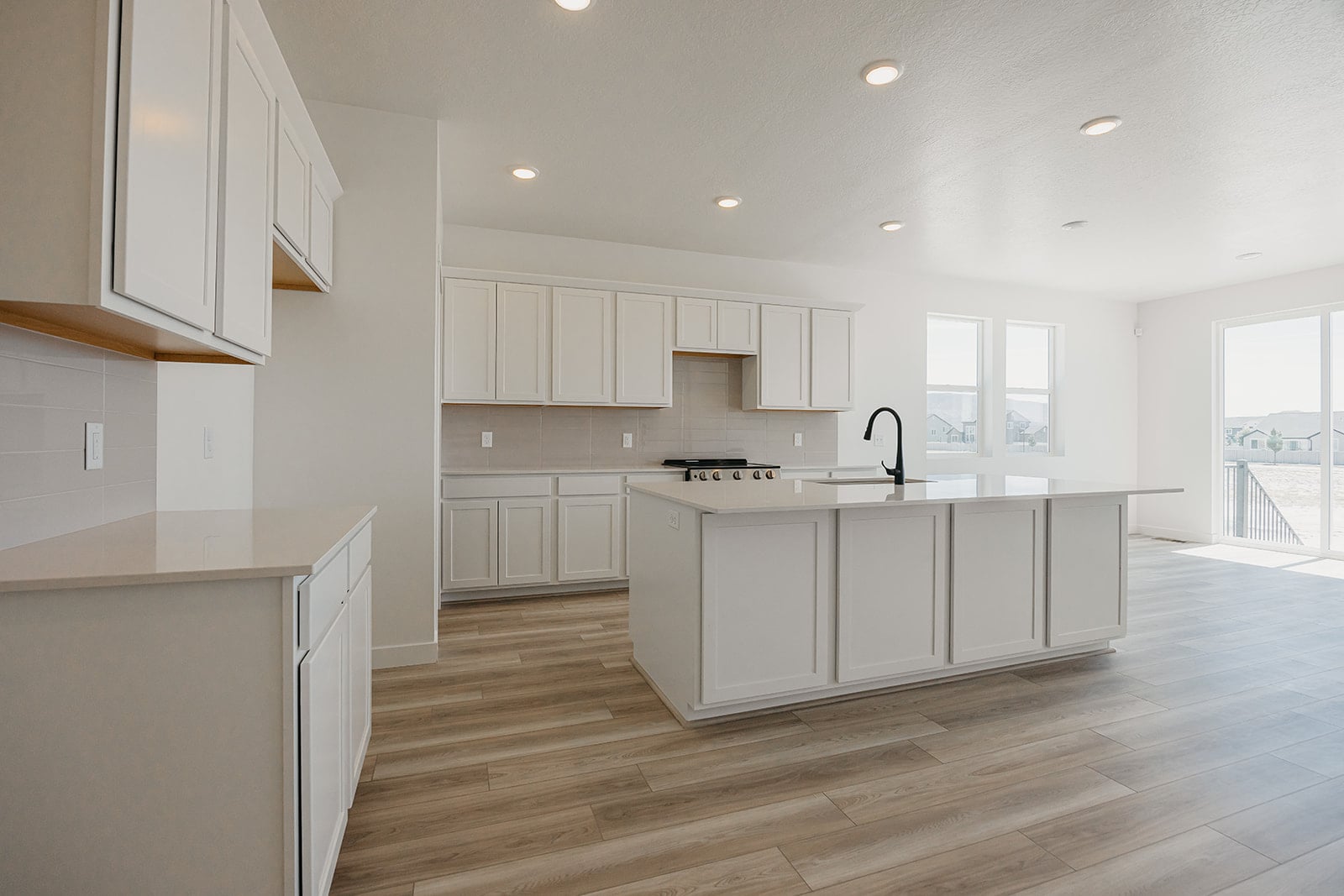 A kitchen with white cabinets.