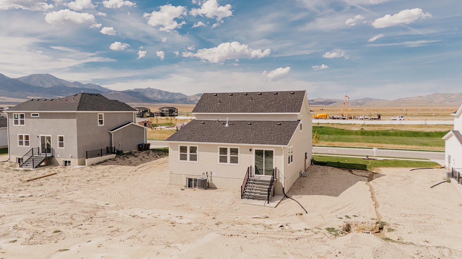 A group of buildings in a sandy area.