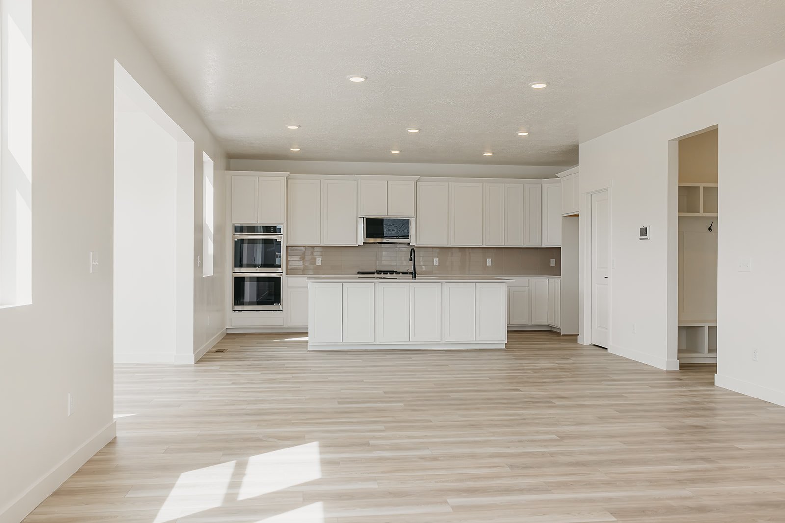 A large kitchen with white cabinets.