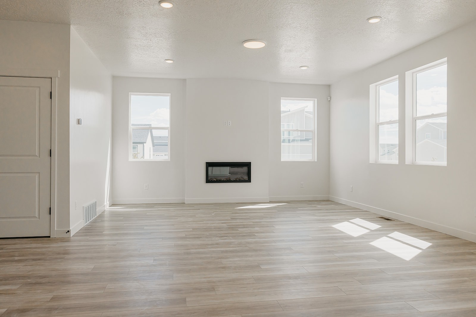A room with white walls and a wood floor.
