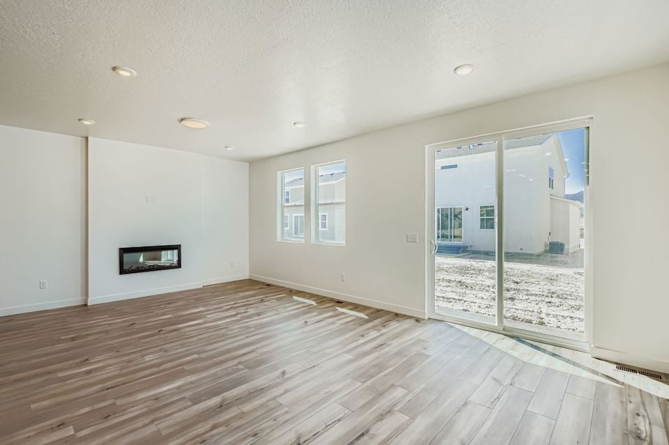 A room with a wood floor and a glass door.
