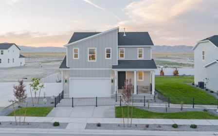 A white house with a black fence.