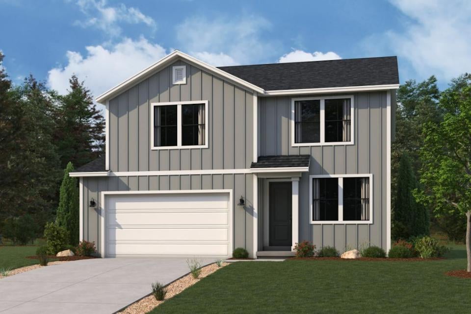 A white house with a garage.