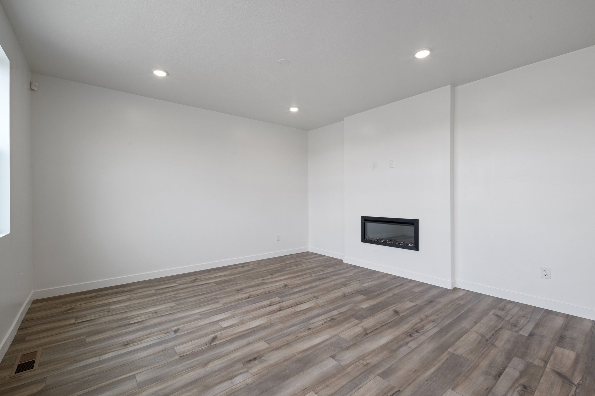 A room with a wood floor and a wood floor.