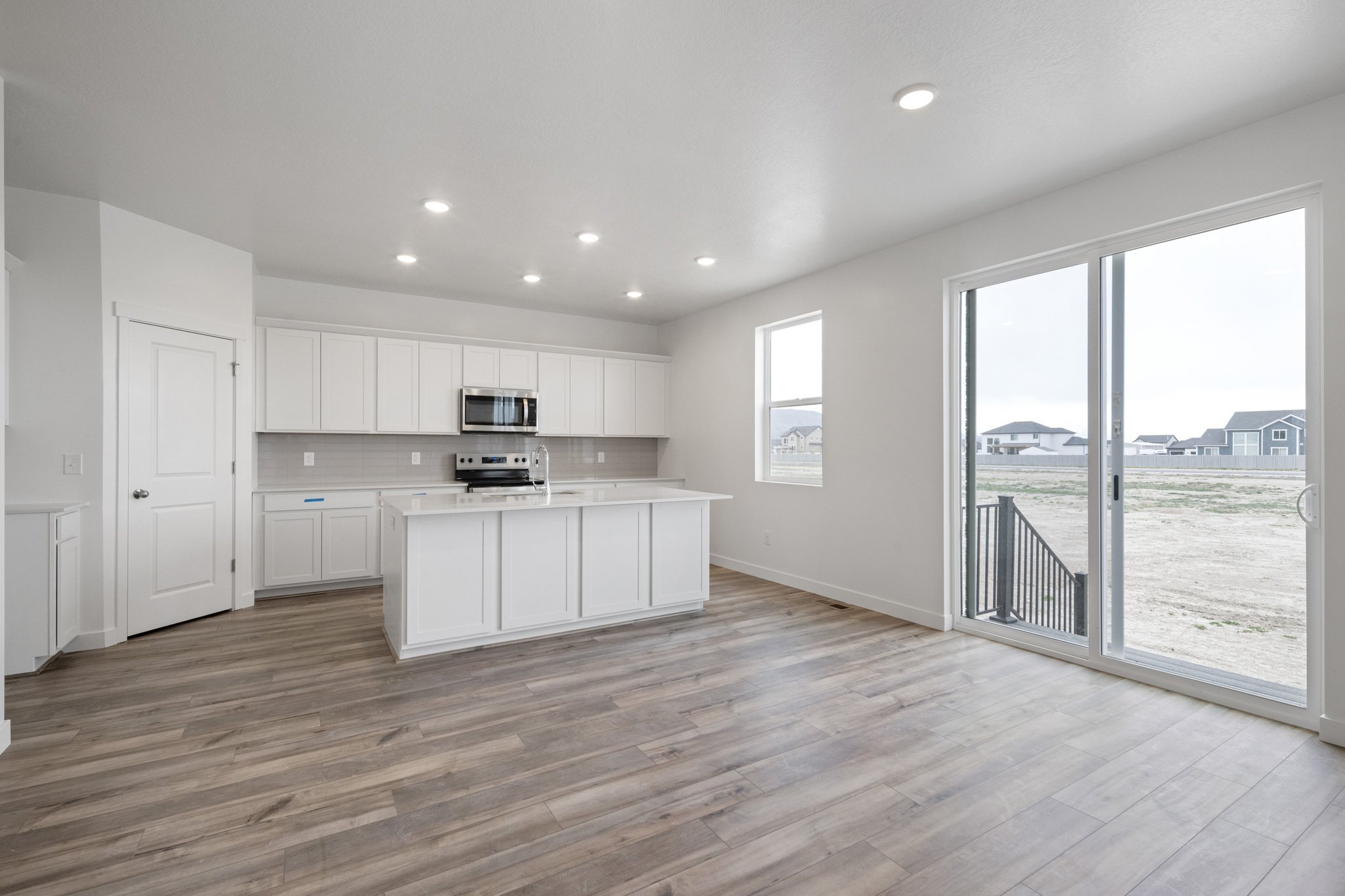 A large kitchen with white cabinets.