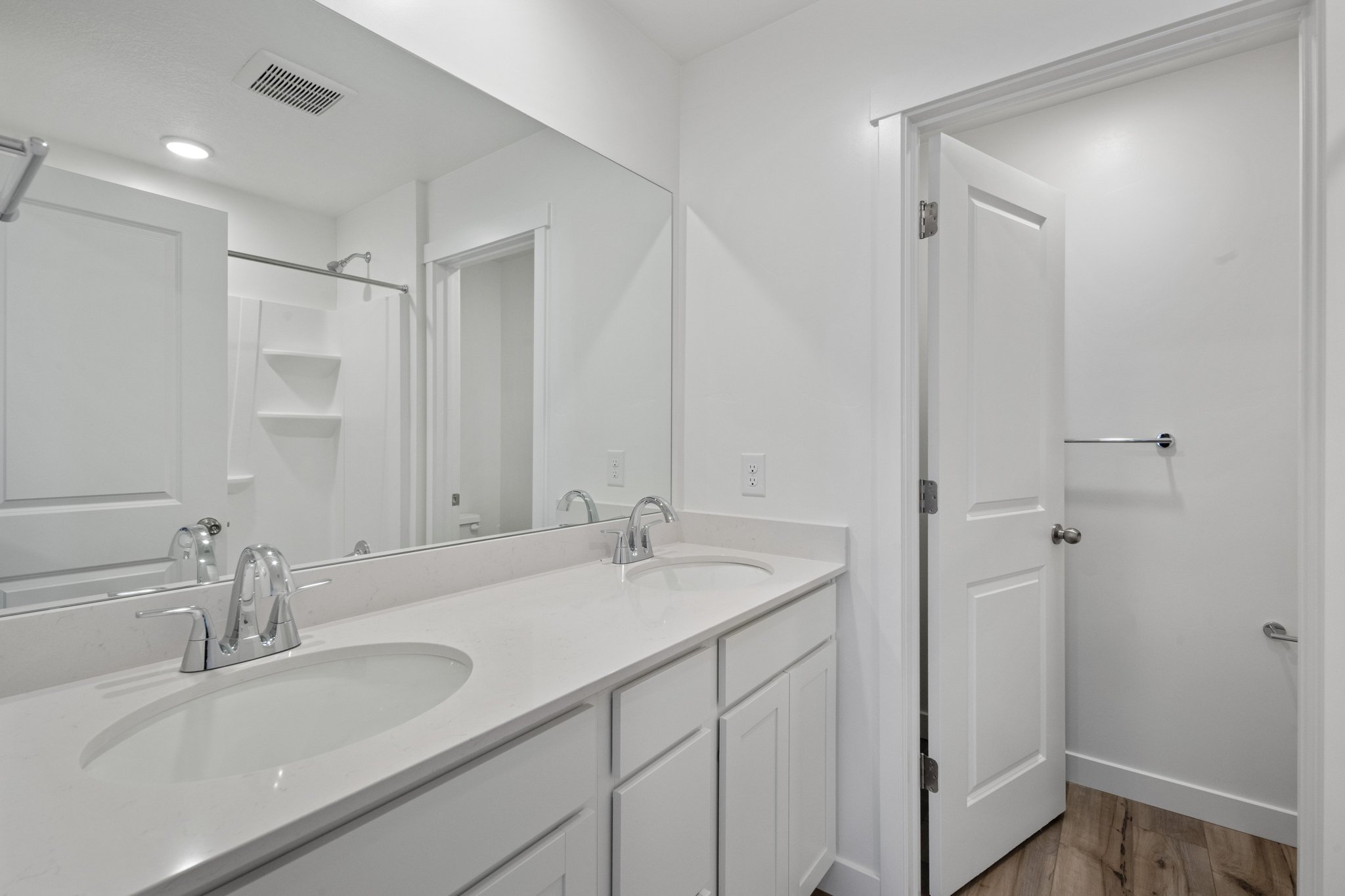 A bathroom with a large mirror.