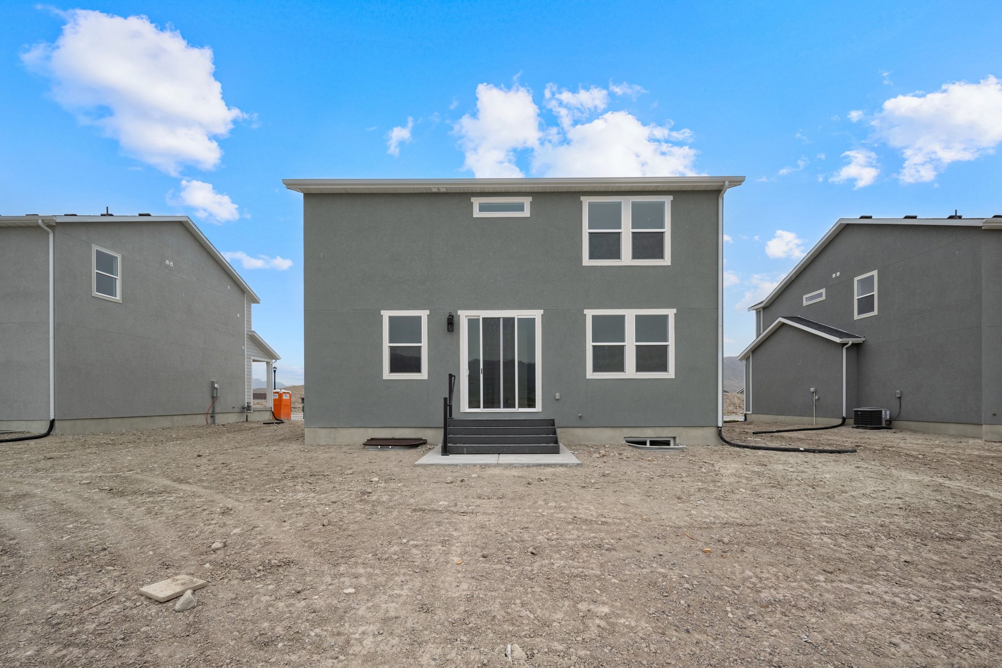 A building with a dirt lot.