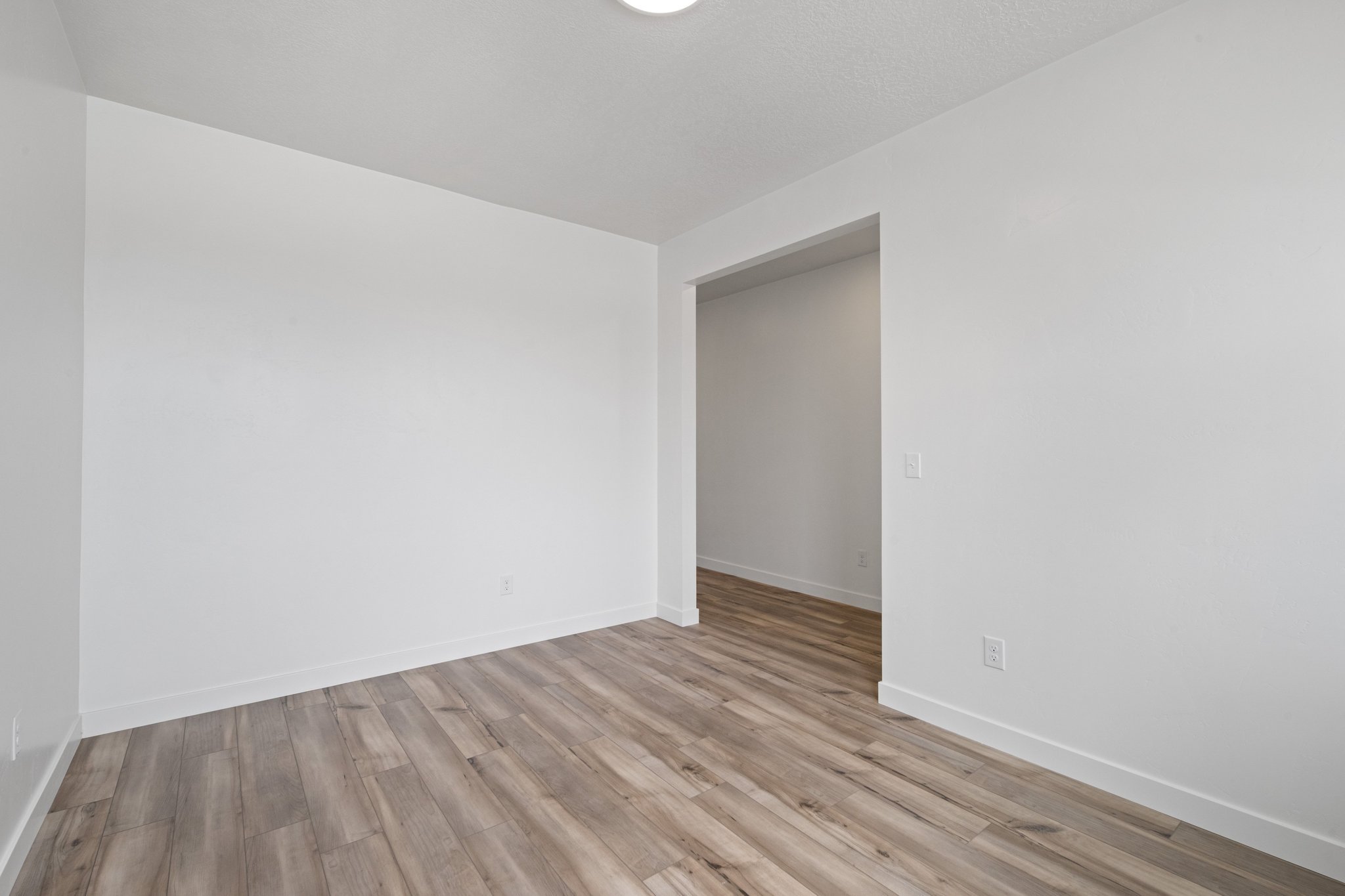 A room with a wood floor and a wood floor.