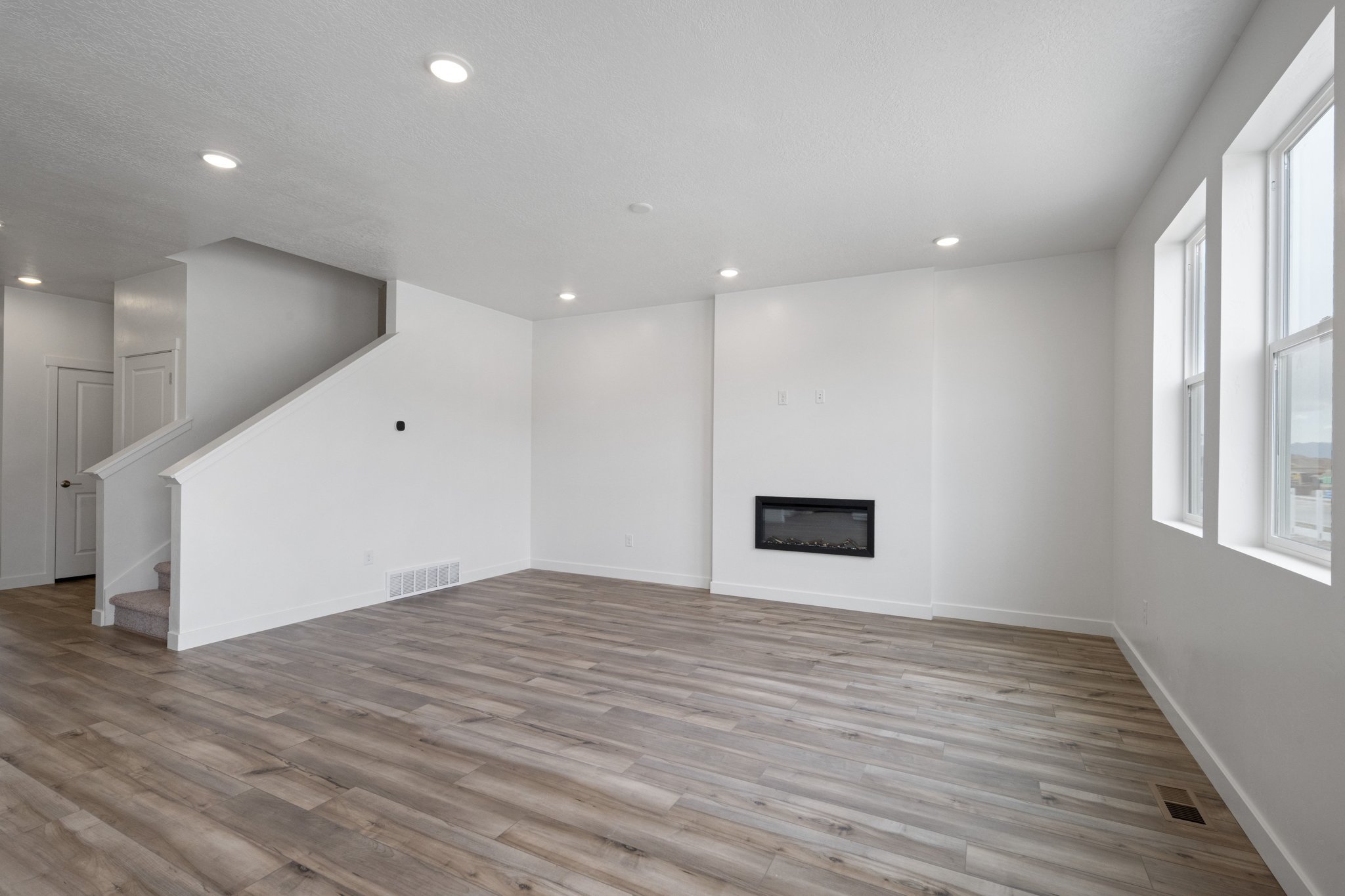 A room with a wood floor and a wood floor.