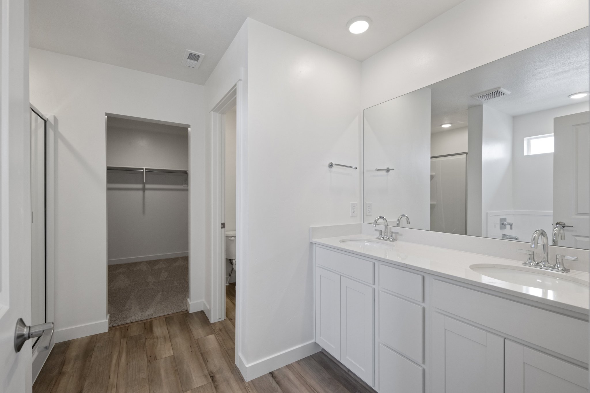 A bathroom with white cabinets.