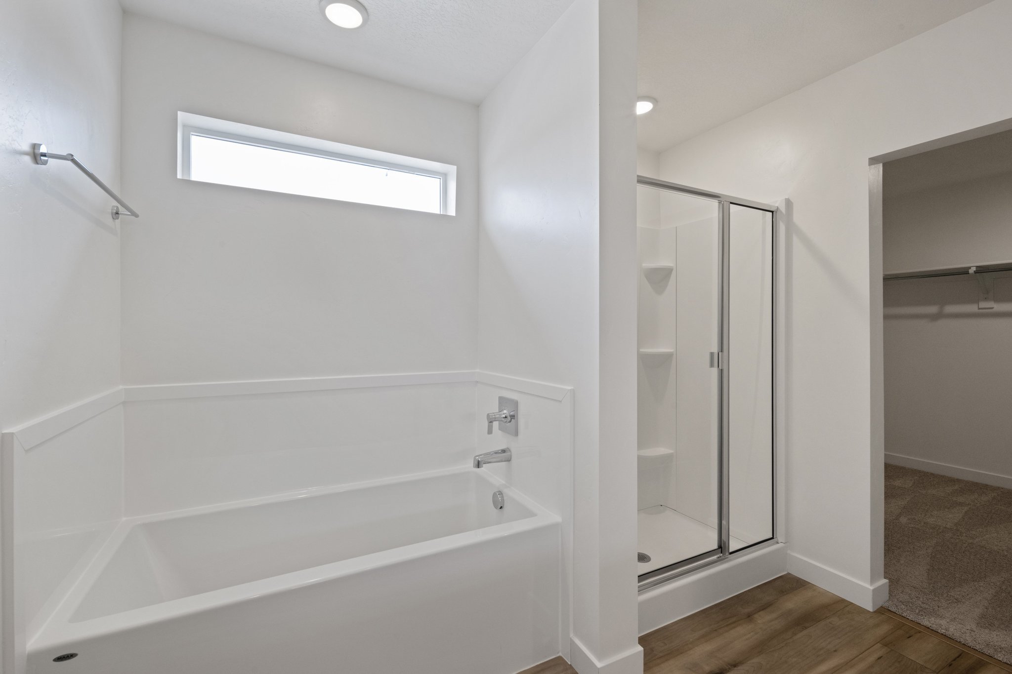 A bathroom with a bathtub and shower.