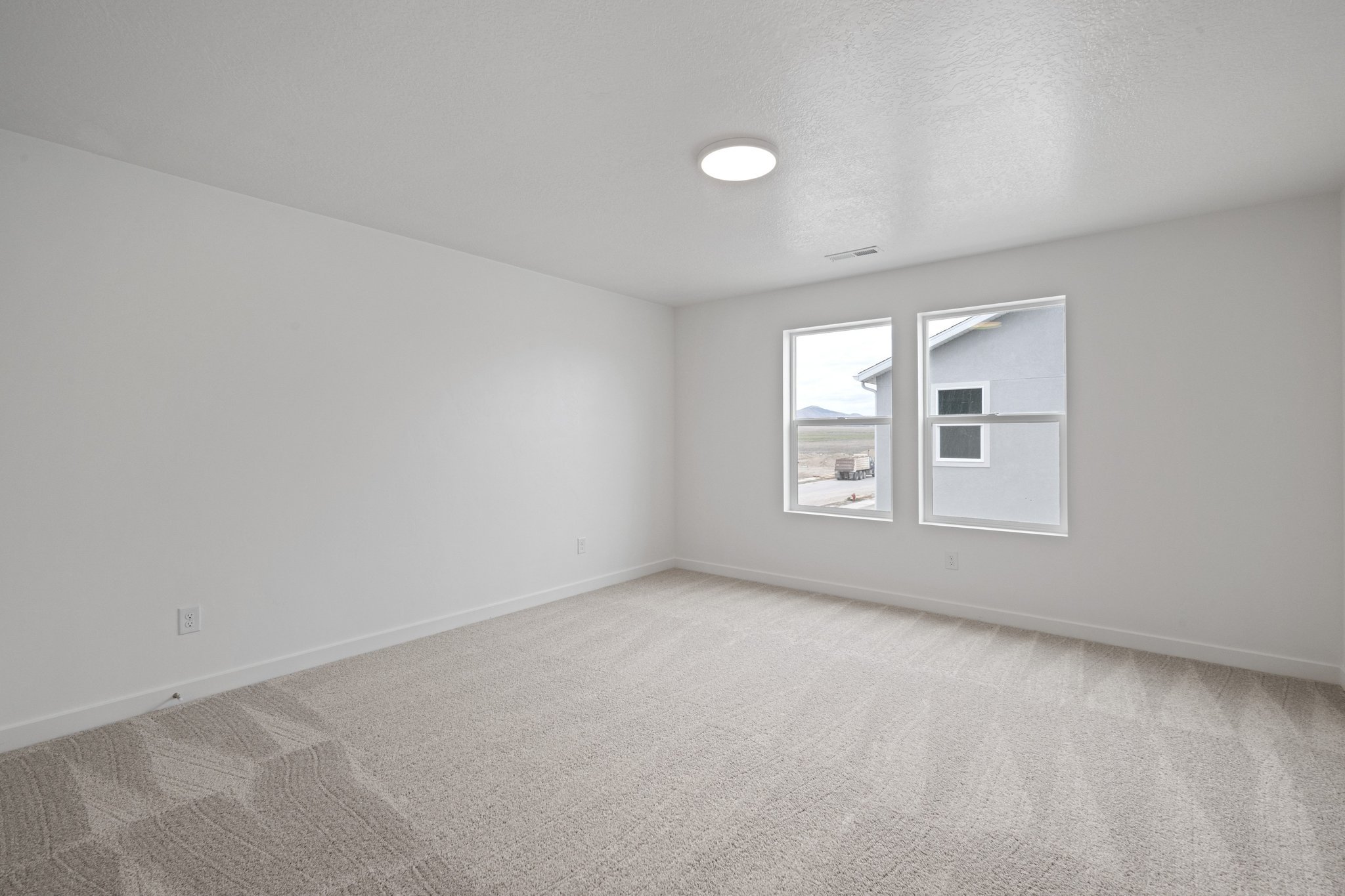 A room with a light on the ceiling.