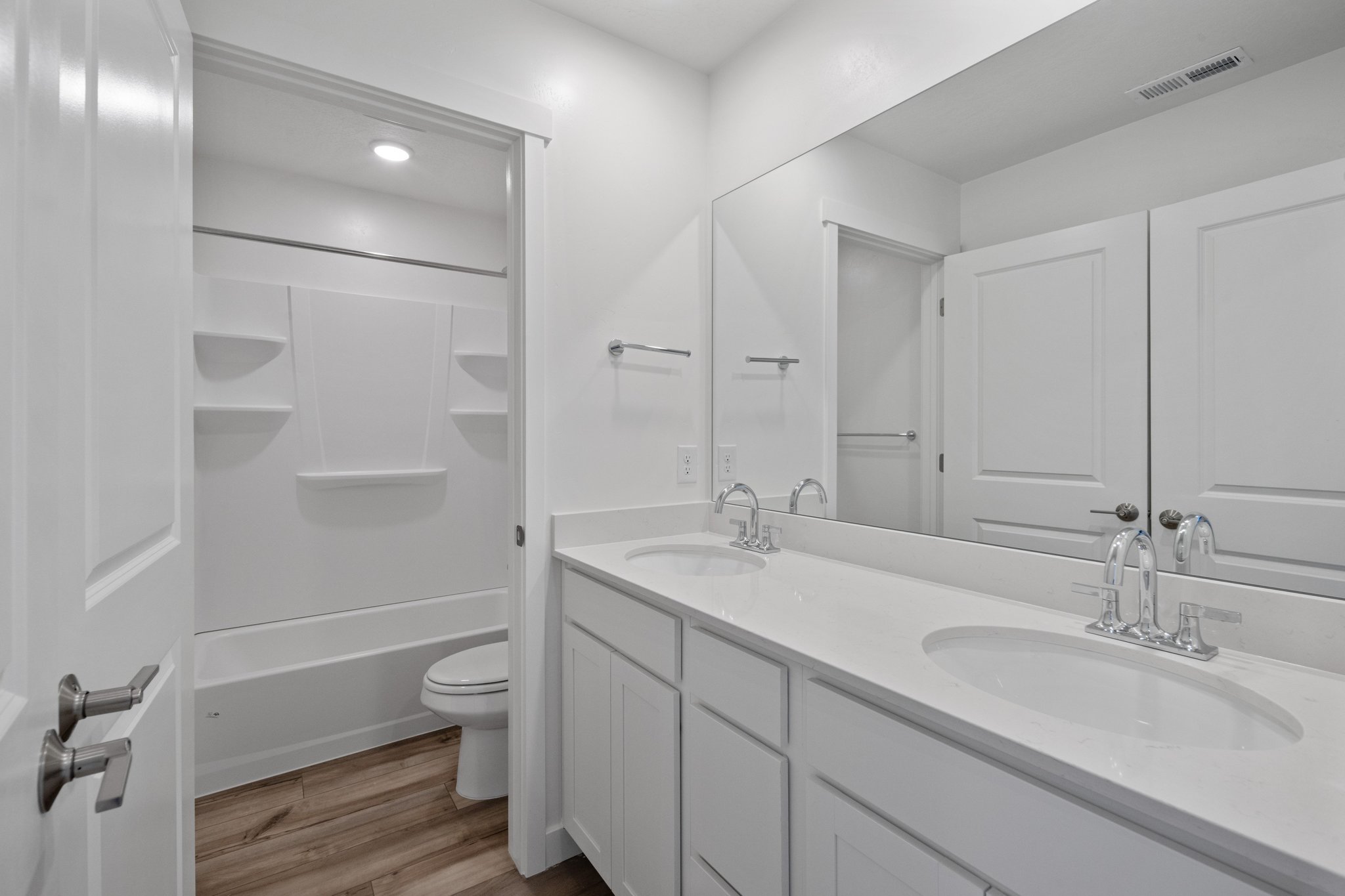 A bathroom with white cabinets.