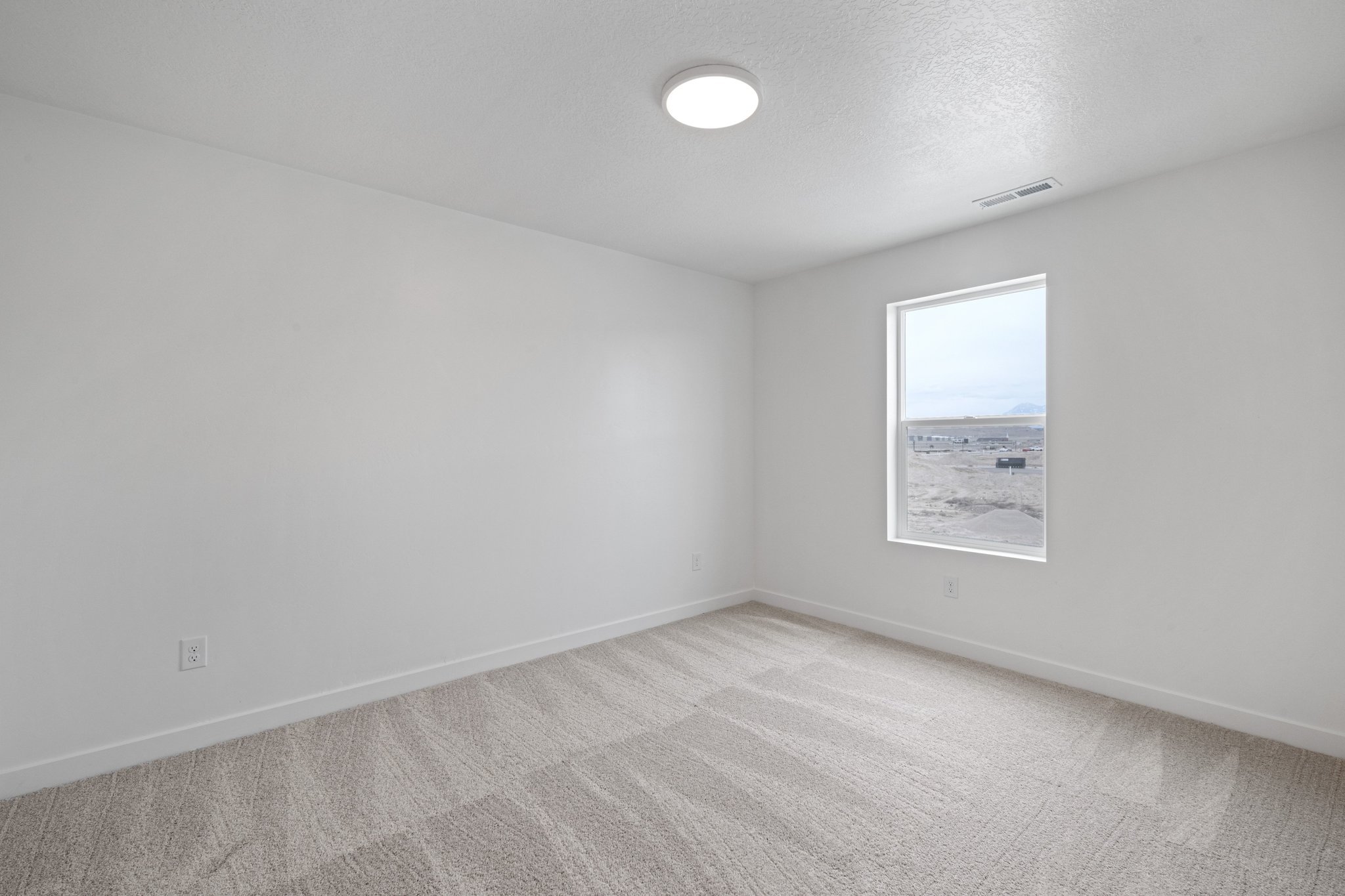 A room with a light on the wall.