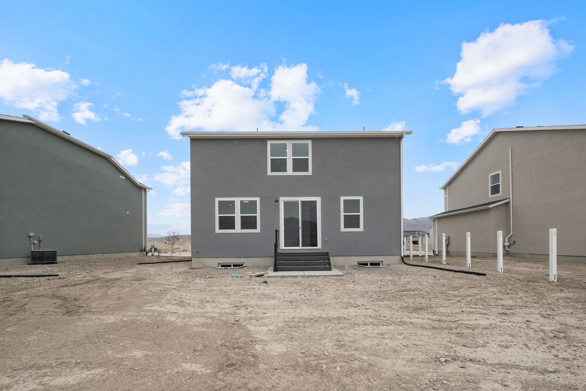 A building with a dirt lot.