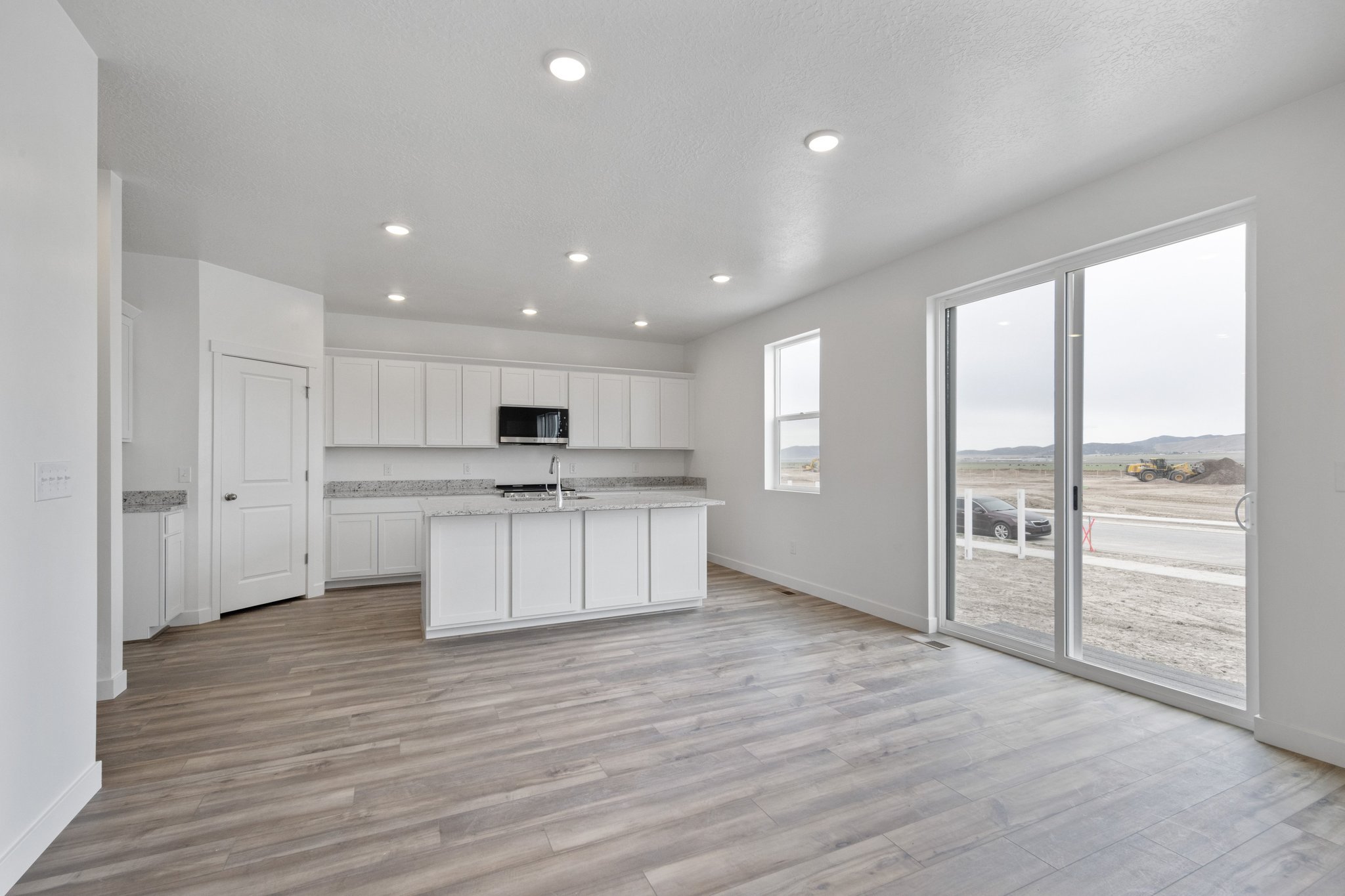 A large kitchen with white cabinets.
