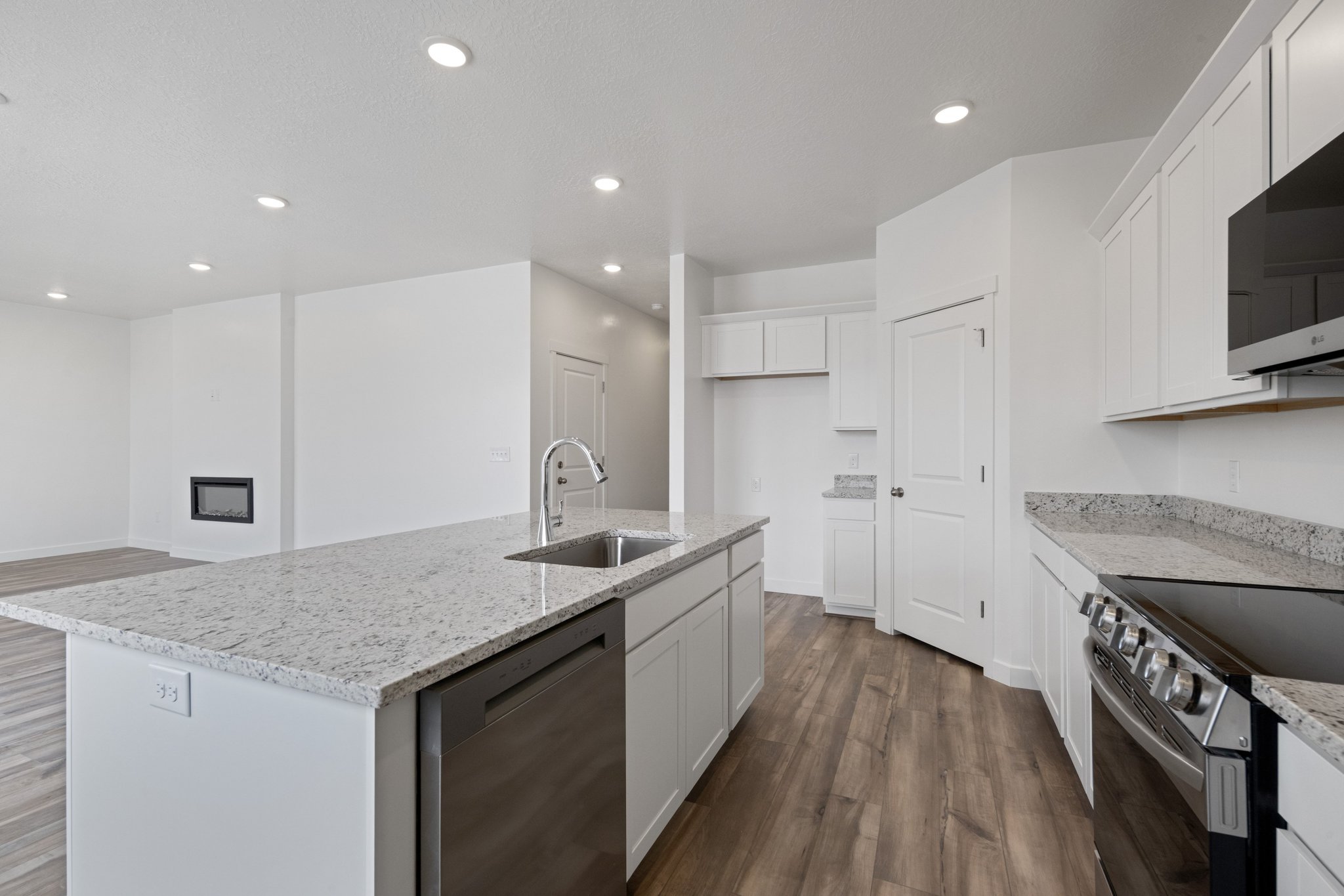 A kitchen with white cabinets.