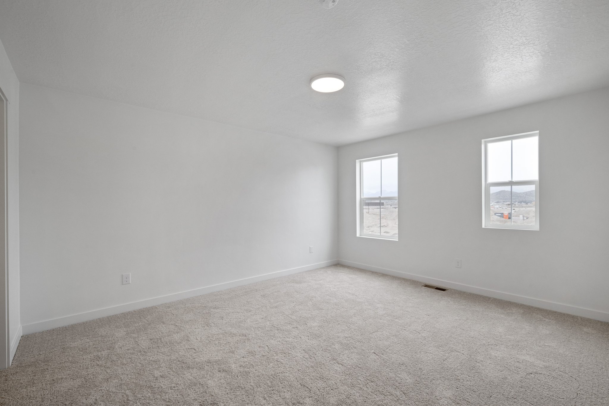 A room with a light on the ceiling.