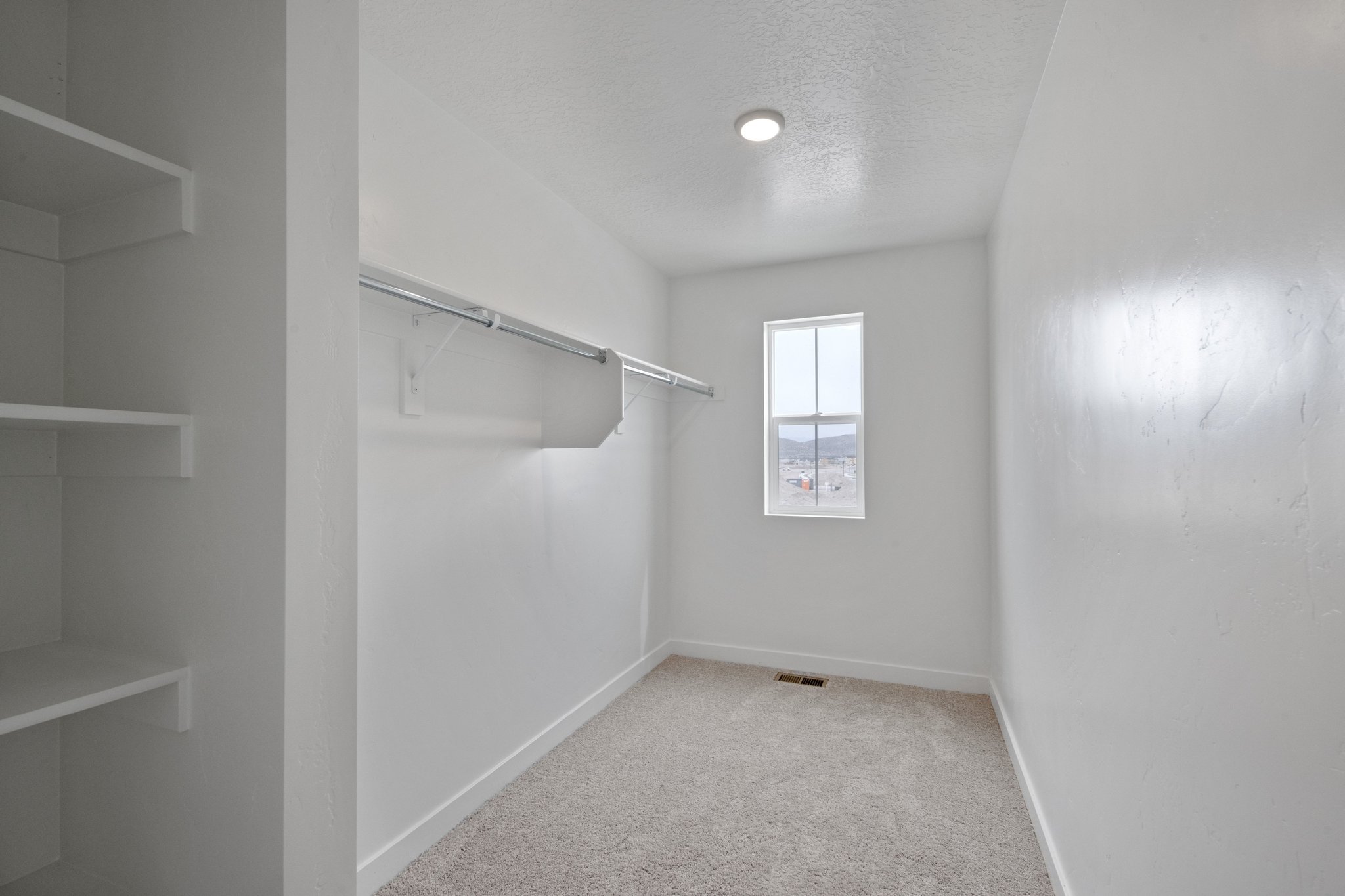 A white room with a window.