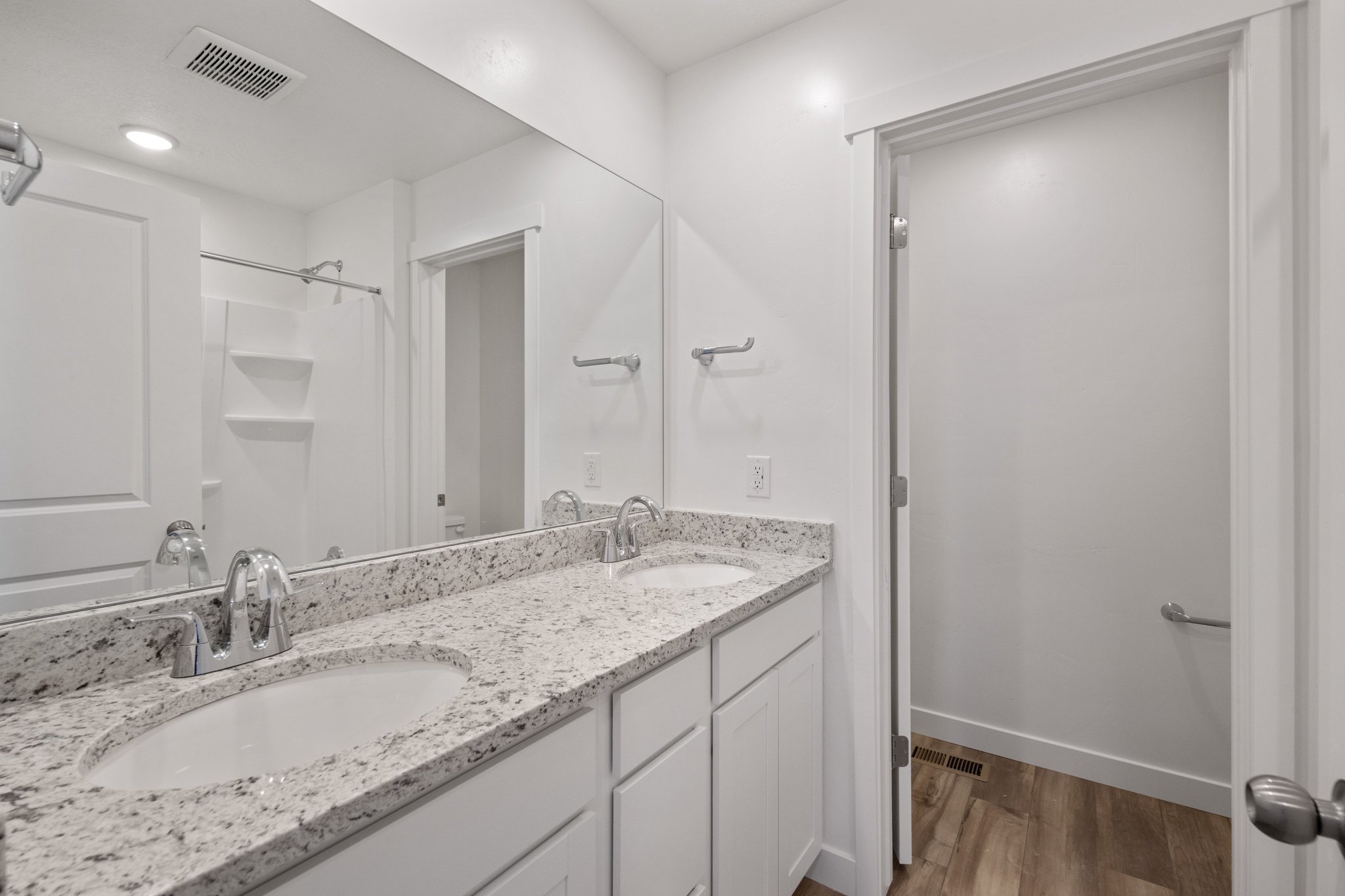 A bathroom with a large mirror.
