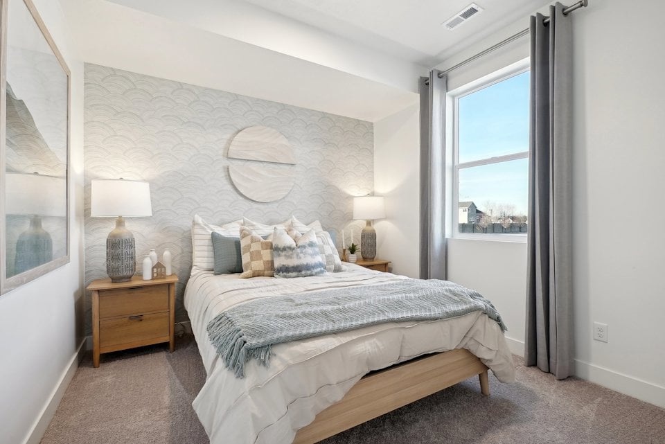 A bedroom with a large window.