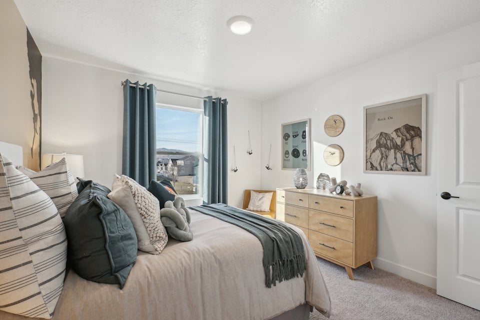 A bedroom with a bed and a window.