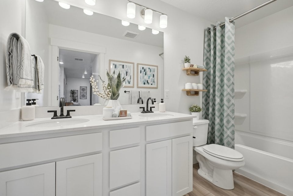 A bathroom with a tub toilet and sink.