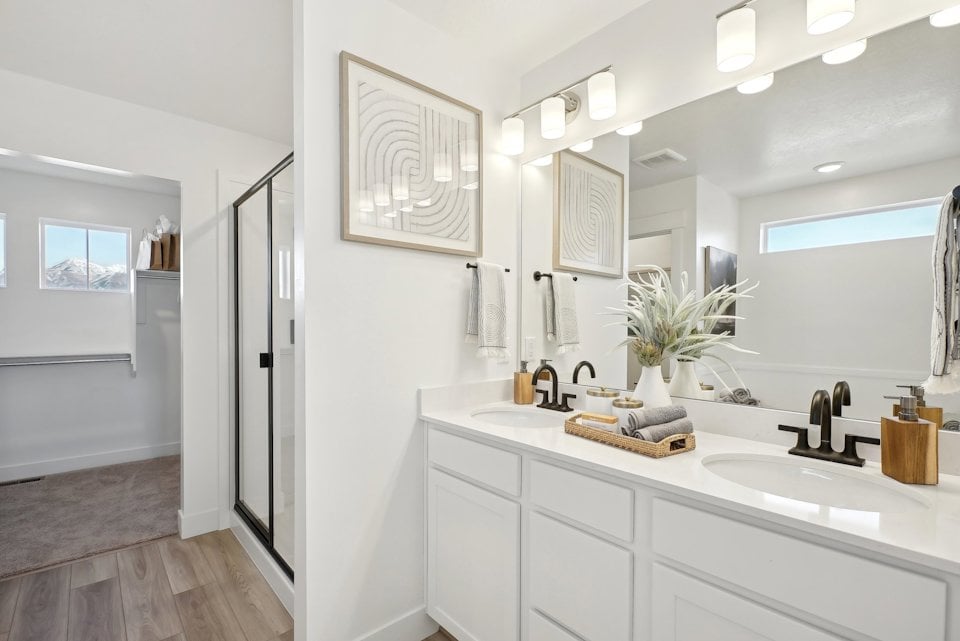 A bathroom with white cabinets.