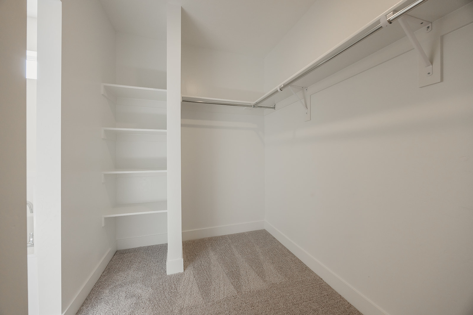 A white room with a white shelf.