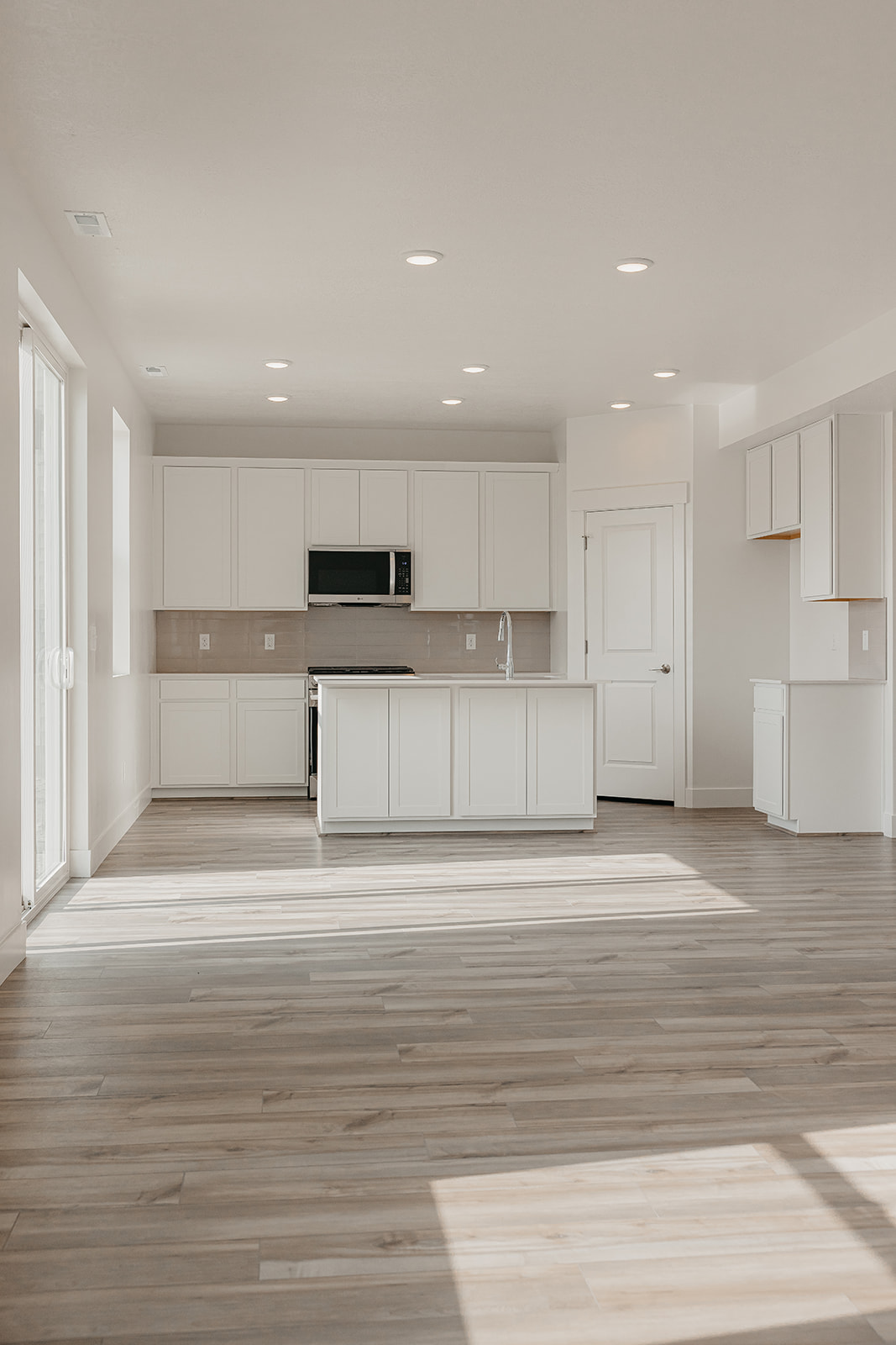 A kitchen with white cabinets.