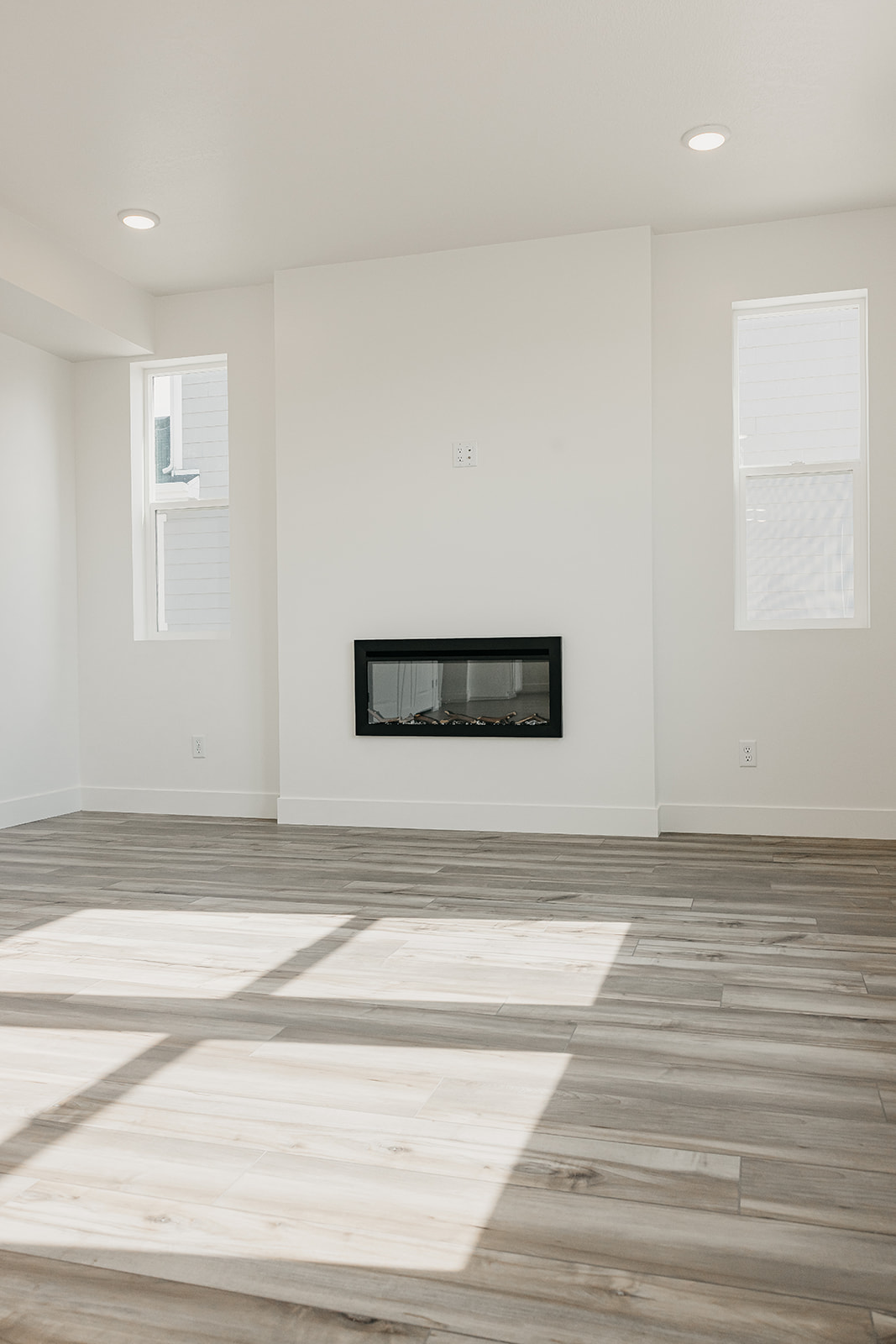 A room with white walls and a wood floor.