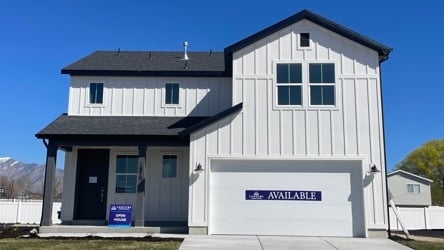 A white building with a black roof.