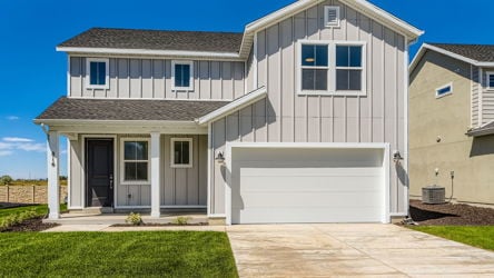 A white house with a garage.