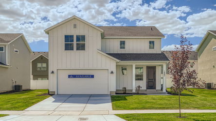 A building with a tree in front.