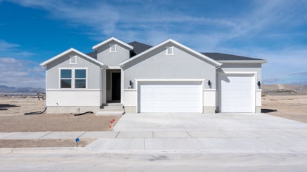 A white house with a garage.