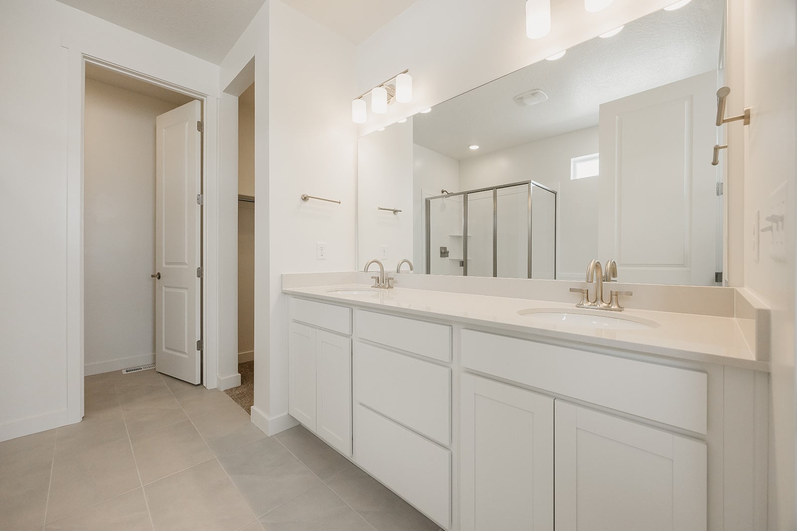 A bathroom with white cabinets.