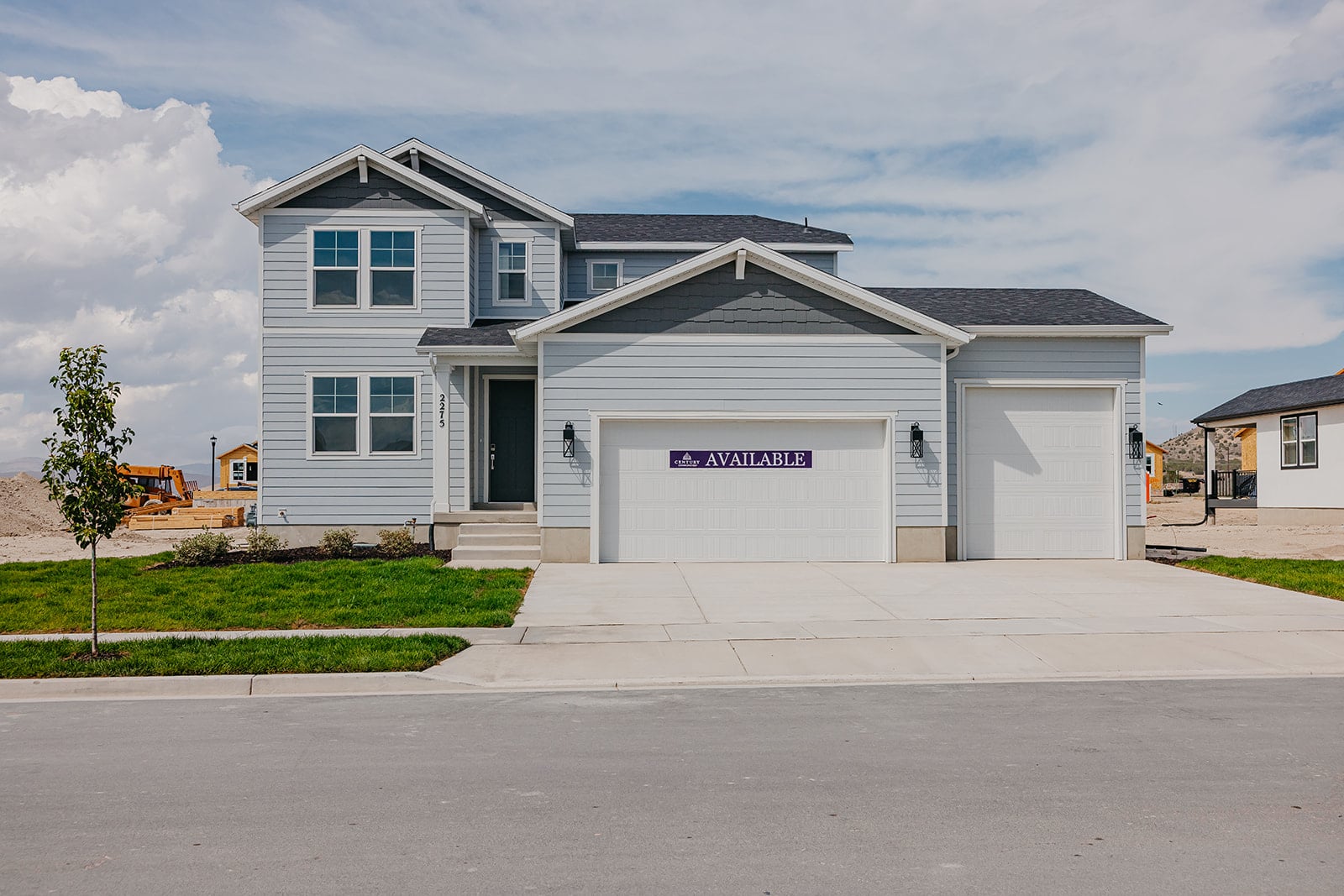 A white building with a garage.