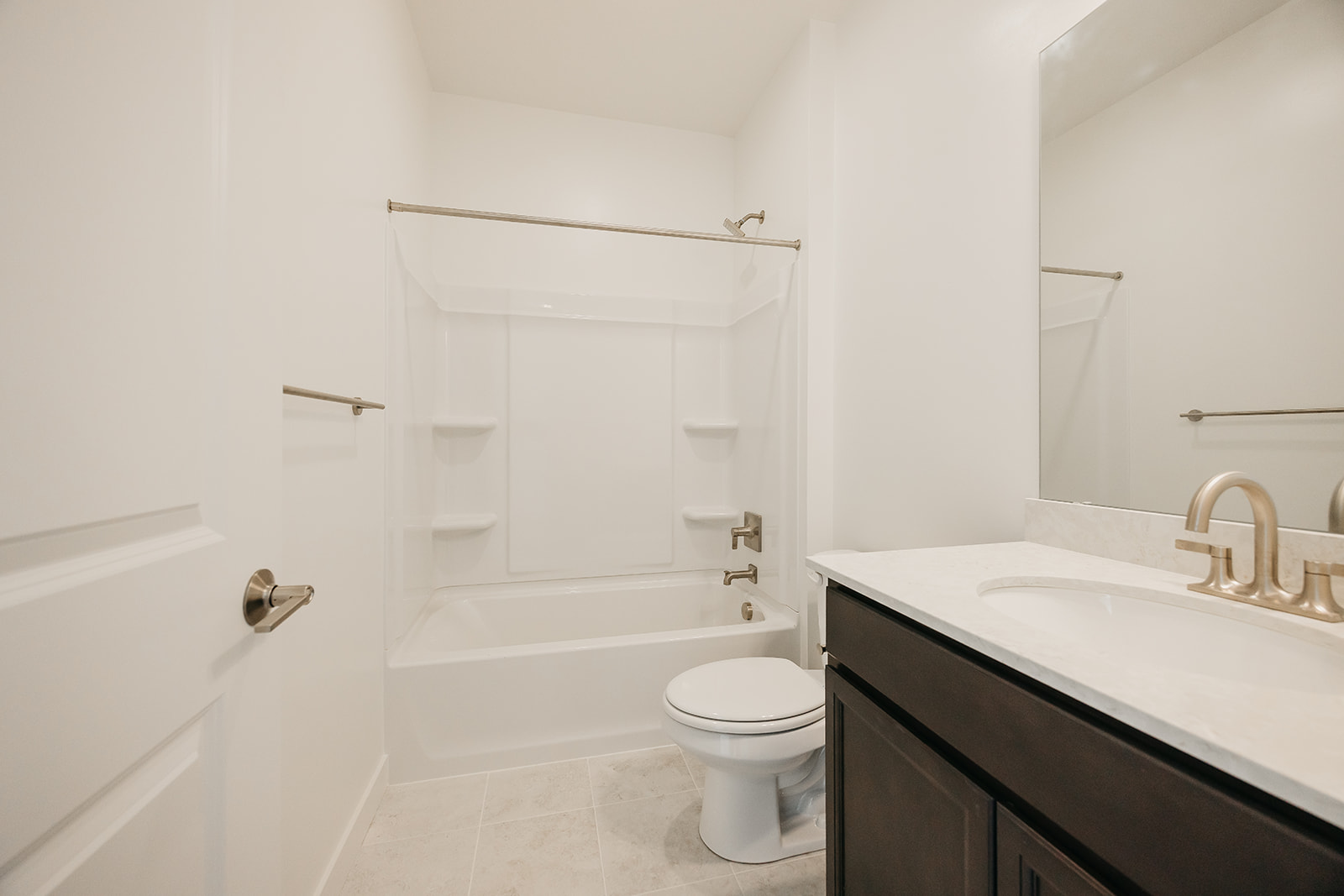 A bathroom with a tub sink and toilet.