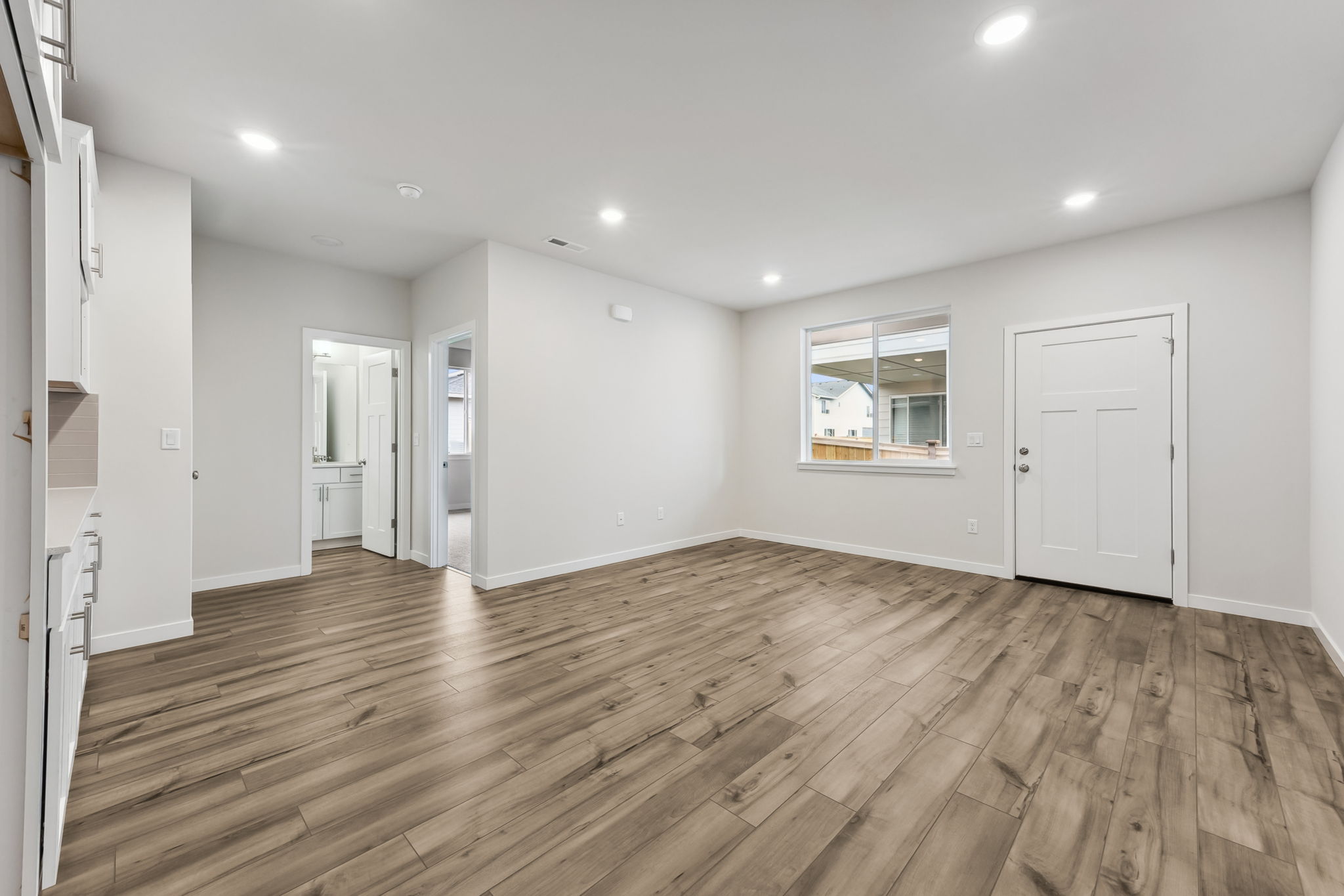 A room with a wood floor and white doors.