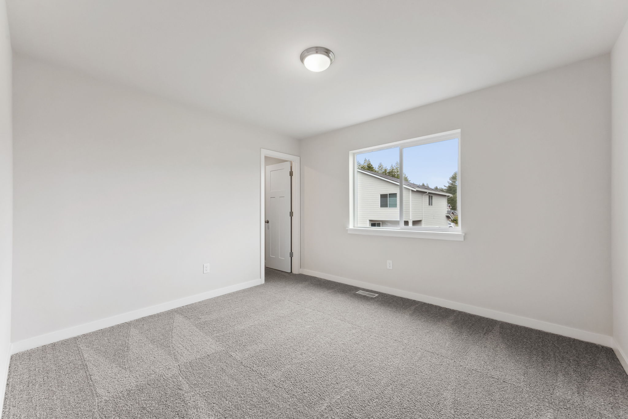 A room with a window and a door.