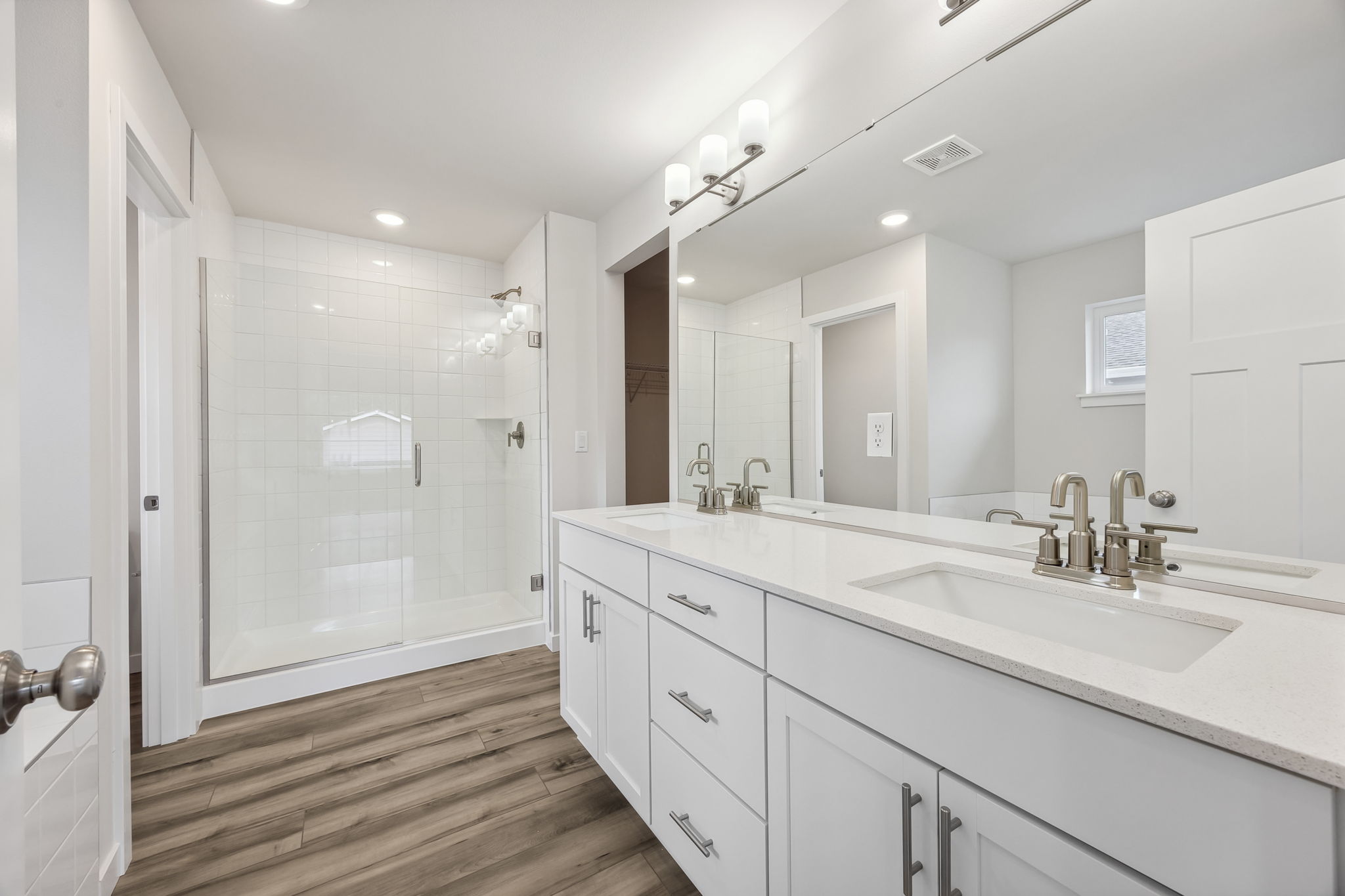 A bathroom with a large mirror.