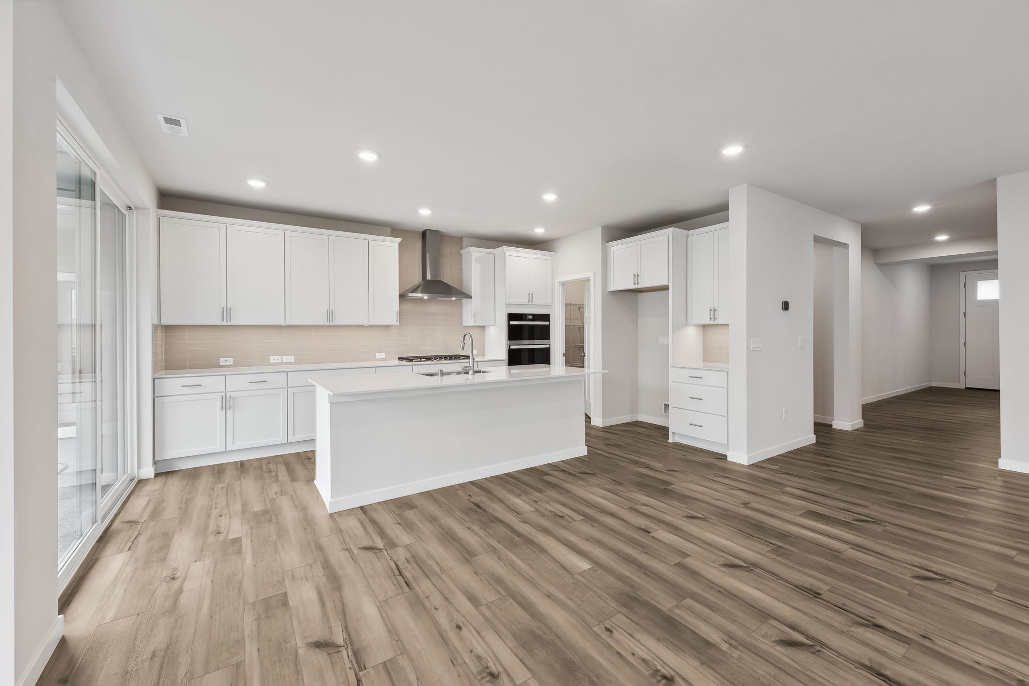 A kitchen with white cabinets.