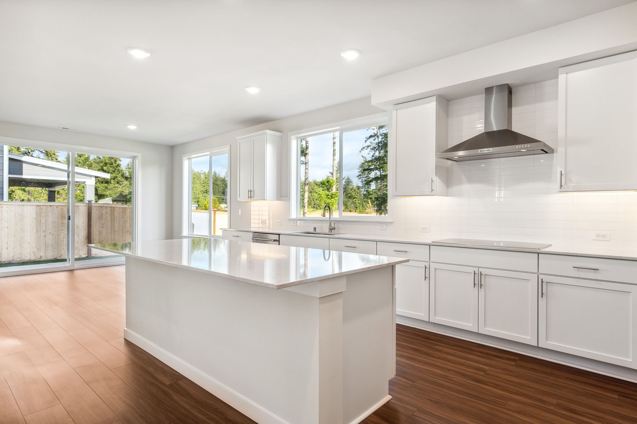 A kitchen with white cabinets.
