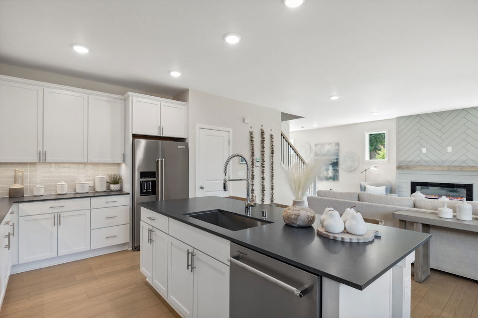 A kitchen with white cabinets.