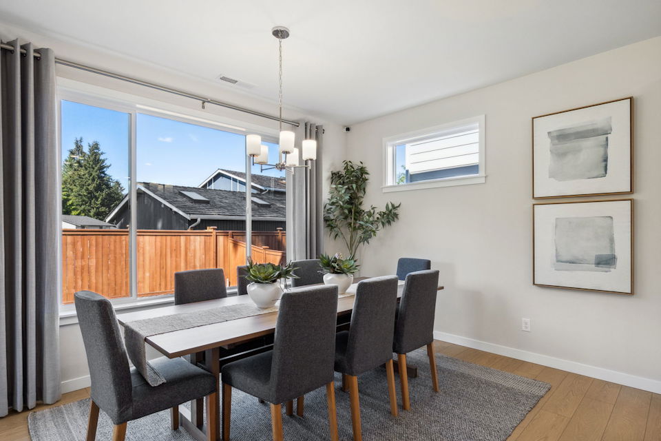 A dining room with a large window.