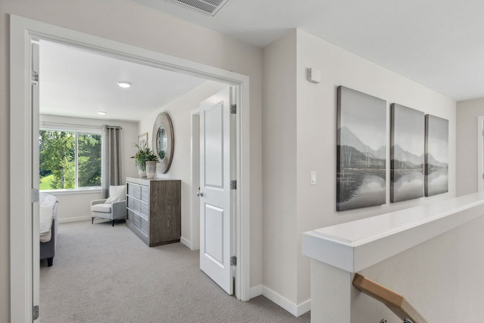 A room with white walls and a white counter with a mirror.